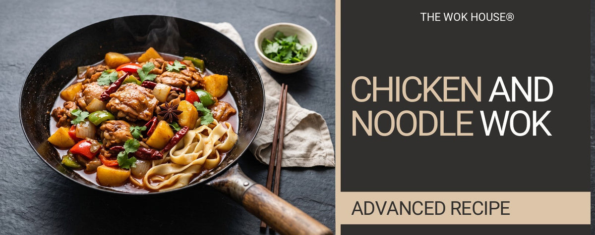 Big plate chicken with potatoes, peppers, dried chillies and star anise over wide noodles in a wok, with a bowl of coriander
