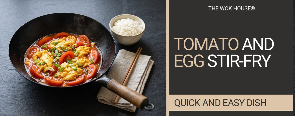 Tomato and scrambled egg stir-fry with spring onion in a black wok, with a bowl of rice and chopsticks on a linen napkin Image