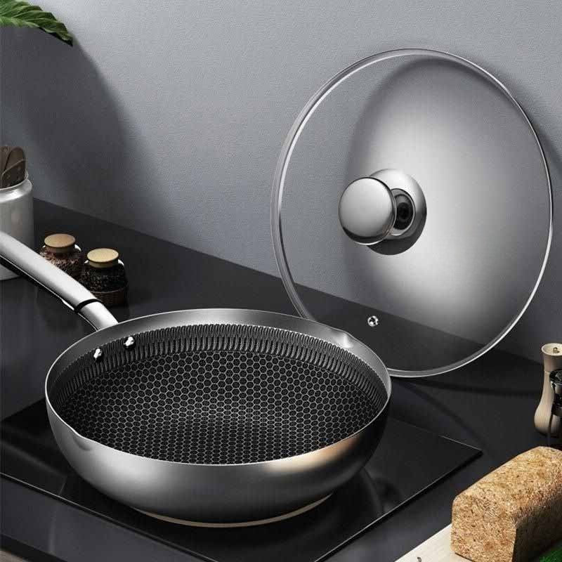 Iwate stainless steel wok with glass lid on ceramic cooktop