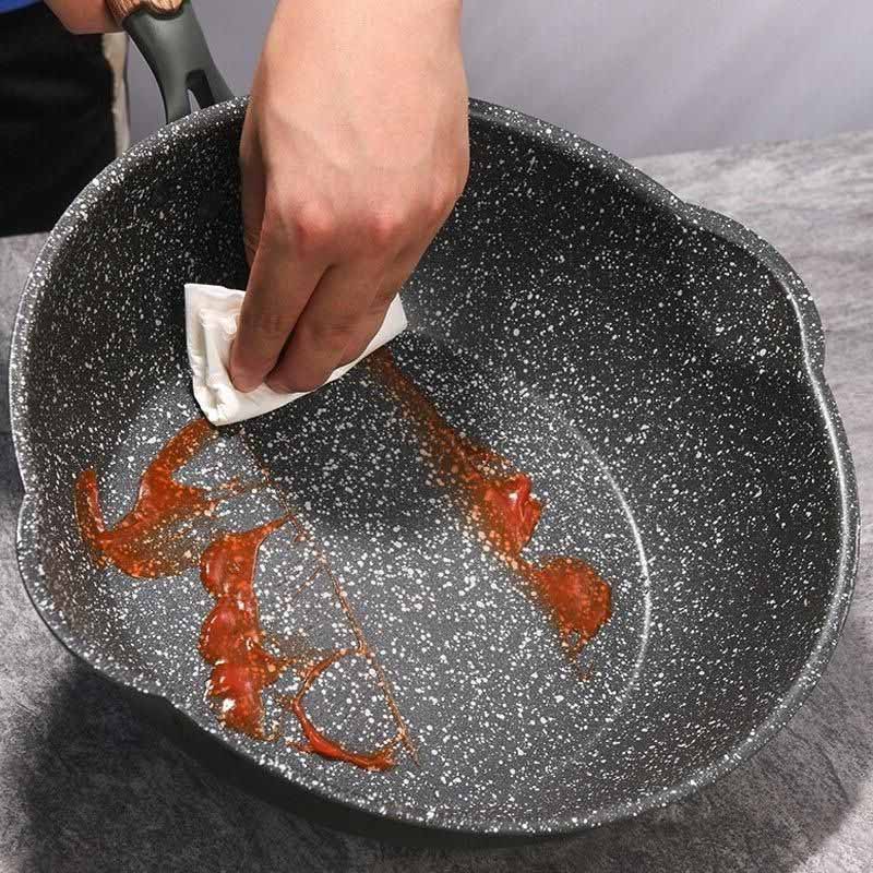 Aso granite wok with glass lid and wooden handle on induction cooktop