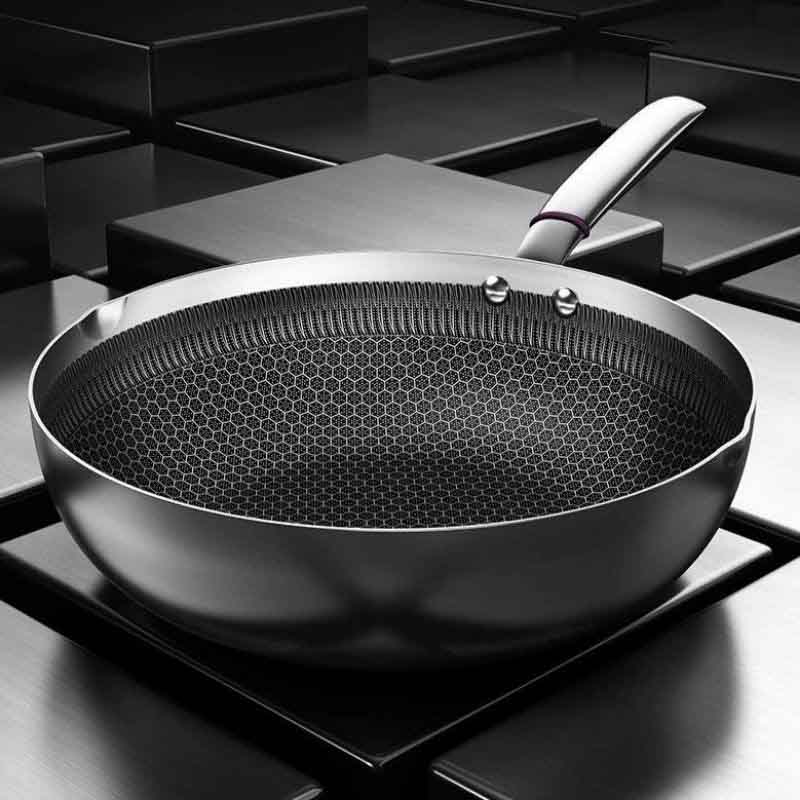 Iwate stainless steel wok with glass lid on ceramic cooktop